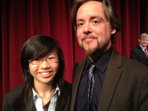 Student moderator Carol Lee with politician Matt Toner (NDP). In the background: Andrew Wilkinson (BC Liberals)